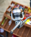 Close-up of Spyn Spinning Fishing Reel Size 20 with aluminum spool and titanium nitride bail wire, silver and black finish