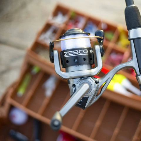 Close-up of Spyn Spinning Fishing Reel Size 20 with aluminum spool and titanium nitride bail wire, silver and black finish