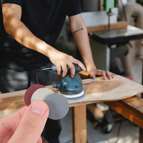 Person using Grab These Awesome Parliky 180 Sheet Round Hook And Loop Sanding Discs for woodworking on a power sander.