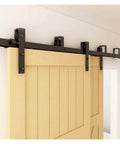 Front view of Bypass Barn Door Hardware Kit For Double Doors With J Shaped Rollers And Quiet Glide installed on wood door.
