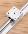 Real Deal SBR12 Linear Rail Shaft Set Built Tough With Four Matching Bushings Featuring Pre Drilled Mounting Holes For CNC Routers 3D Printers And Robotics Projects, close-up of bearing block on steel shaft.