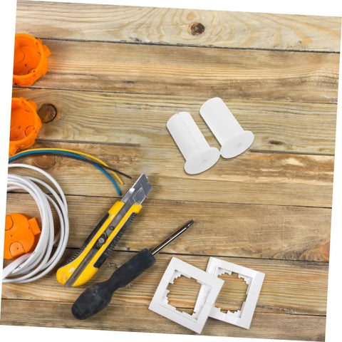 Premium Silicone Antenna Protectors And Wall Hole Plugs For Seamless Drywall Cable Routing. White silicone grommets with cable, tool, and wall plates on wood.