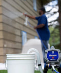 Heavy Duty Airless Paint Sprayer For Interior And Exterior Tasks Featuring Fully Adjustable Pressure Control And Reliable Power in use with paint bucket.