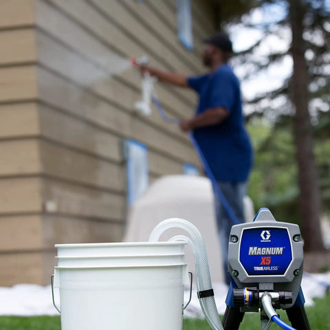 Heavy Duty Airless Paint Sprayer For Interior And Exterior Tasks Featuring Fully Adjustable Pressure Control And Reliable Power in use with paint bucket.