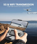 Hands holding controller on rocky shore showing 5G transmission with Beginner Friendly Foldable Drone With 4K Camera And Brushless Motors Auto Follow Tap Fly Circle Fly One Key Start Ultra Light Under 249g For Easy Travel And Epic Aerials flying