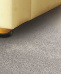 Slick Polyethylene Furniture Sliders Made To Fit Round Table And Sofa Legs under a sofa leg on a smooth gray surface.