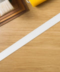 Self Adhesive Cable Raceway Cord Cover For Walls Sorts Messy Wiring Straight Up While Keeping Your Setup Tidy With Pvc Strips on a wooden surface.