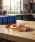 Straight Up Pure Copper Welding Strips For Ev Battery Packs And Power Modules Smooth Thin Copper Metal Roll on workbench with EV battery.