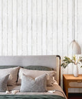 Peel And Stick Dope White Gray Wood Shiplap Wallpaper 511.8 Inch By 17.7 Inch in a bedroom setting with nightstand and lamp