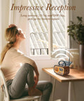 Woman at table with J-150 Portable Radio AM FM SW Bluetooth Speaker with retro look and solar USB charging shown in sunlight