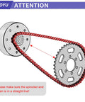 Side view of red go-kart roller chain around silver sprockets.