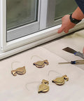 Heavy Duty Sliding Screen Door Tension Spring Rollers With One And One Quarter Inch Steel Concave Ball Bearing Wheels Fits KDEX20 Series KD Screen Doors Four Pack Replacement shown beside an installation site with tools