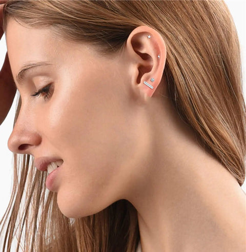 18 Pairs Tiny Cartilage Stud Earrings For Women And Men, Star Moon Heart Disc Ball CZ, Flat Back Screw Back Earrings, Stainless Steel Geometric Barbell Piercing Set, Silvery Finish, Everyday Sparkle For All Ear Piercings. Women wearing tiny stainless steel cartilage studs on ear