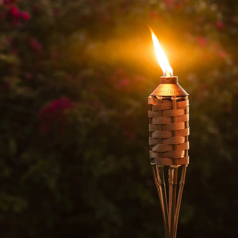Easy Pour 12 Pack Bamboo Torch Set With Classic Weave Brown Finish Outdoor Lawn Patio Garden Lighting illuminated at night