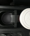 Car cup holder with Two Pack Bling Car Cup Coasters Set For Women With Non Slip Silicone Inserts, securing a cup.