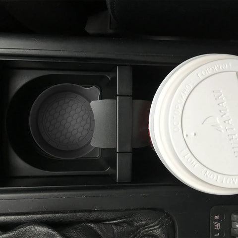 Car cup holder with Two Pack Bling Car Cup Coasters Set For Women With Non Slip Silicone Inserts, securing a cup.