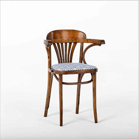 Wooden chair with curved backrest and patterned blue cushion on white background
