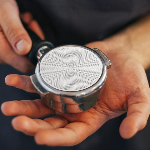 Hella Smooth Reusable Stainless Steel Coffee Filter Fine Mesh shows fine mesh screen in hand, compatible with 51Mm brewers for bold flavors.