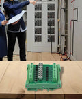 8 Channel Optocoupler Isolator Module For PLC DC Output Board on table, electrical panel in background