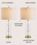 Clear Glass Triple-Sphere Table Lamps Set Of 2 With Brass Accents And White Linen Shade 27-Inch Tall Modern Bedside Lamps For Living Room Bedroom Or Office LED Bulbs Included, showcasing glass spheres and linen shade.