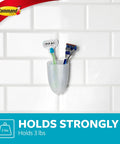 Clear Frosted Bath Razor Holder with Water Resistant Strip holding razors and toothbrush on tiled shower wall