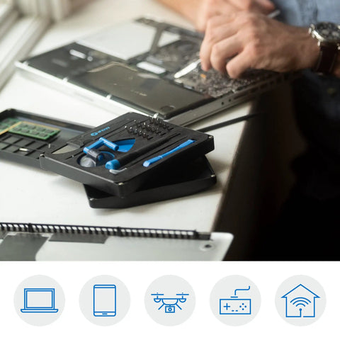 All In One Electronics Repair Kit With 16 Precision Bits And Magnetic Screwdriver on desk next to open laptop