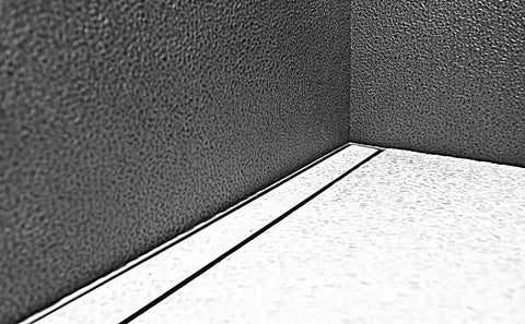 Inside corner view of Dead Simple 60 Inch Tile Ready Floor Drain Channel Kit with textured walls and floor finish.