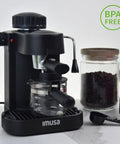 Straight Up Home Barista Vibes With This Compact 4 Cup Electric Espresso And Cappuccino Maker Featuring A Durable Milk Frothing Pitcher For Quick Daily Grind Sessions, black machine with glass pitcher on counter.