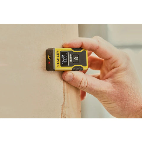 Laser Pocket Measure 12 m Handheld Distance Tool For Pros, Contractors, And DIYers, Compact And Durable Laser Measurer With Quick Readouts, Accurate Measurements, Ideal For Carpentry, Interior Design, And Renovations Model STHT77666-0 measuring a wall corner