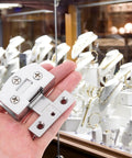 Heavy Duty Stainless Steel Glass Door Hinges With No Sweat Drill Free Mount For Tempered Glass Panels, showcased in a display cabinet.