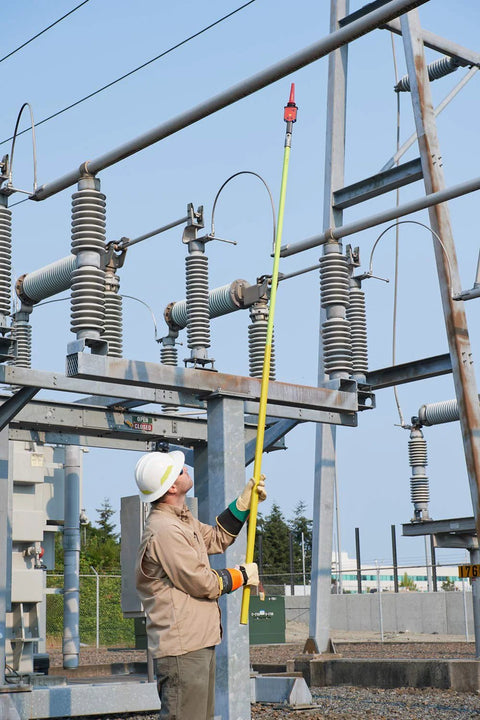 Technician using high voltage detector kit for field techs 30 V to 122 kV AC intrinsically safe pro grade MSHA certified on power lines.