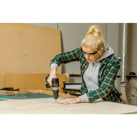 Woman using Compact 1/2 Inch 20V Cordless Drill Driver Featuring Brushless Motor And Adjustable Torque Settings on wood.