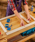 Person using 3/8 Inch Doweling Jig Kit With Drill Bit And Stop Collar, Dual Edge Stops For Easy Alignment on wooden frame.