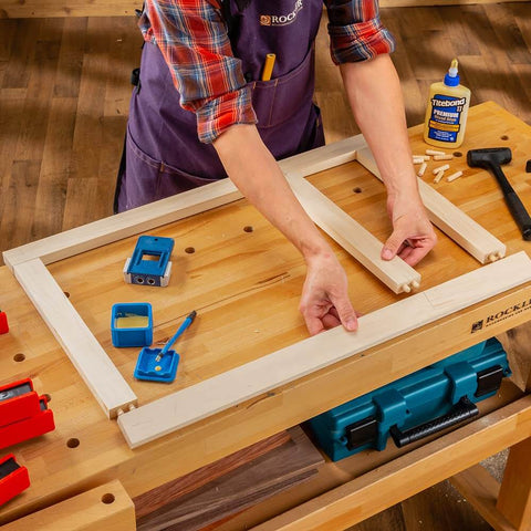 Person using 3/8 Inch Doweling Jig Kit With Drill Bit And Stop Collar, Dual Edge Stops For Easy Alignment on wooden frame.