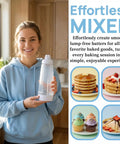 Person holding All In One Pancake Batter Dispenser With BlenderBall and desserts in kitchen scene.