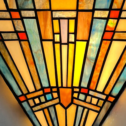 Close-up of a Tiffany Style Wall Sconce With Stained Glass Shade showcasing intricate geometric stained glass patterns.
