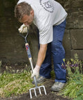Man using Heavy Duty Digging Fork With Forged Carbon Steel Tines For Tough Soil Aeration And Cultivation in a garden