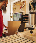 Smooth Operator 4 Piece 1/4 Inch Shank Flush Trim Router Bit Set With Bottom Bearings And Quick Swap Blades in a woodshop.