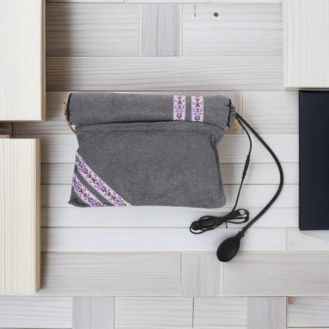 Super Cozy USB Inflatable Heated Neck Pillow With Washable Cotton Cover And Relaxing Aroma For Ultimate Work Travel Stress Relief and Healthy Posture Support in grey with decorative strap.