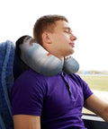 Man using U Shaped Travel Neck Pillow With Skiing Squirrel Design on bus, ergonomic comfort for long flights, supports head and neck.