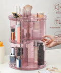 Eight Height Adjustable Spinning Makeup Organizer With 360 Degree Spin Cosmetic Display Carousel in pink plastic, shown in use.