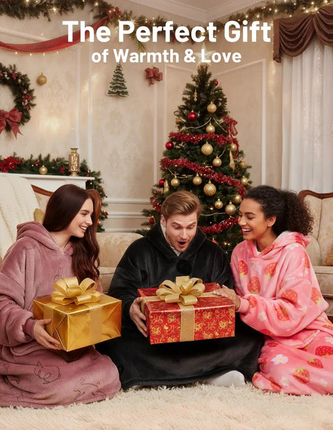 Three people wearing wearable blanket hoodie for adults with flannel and sherpa lining around a Christmas tree, holding gifts.