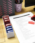 Top Tier Self Inking Office Stamp Set With Eight Gotta Have Rubber Phrases Like Paid And Approved For Smooth Sailing Daily Tasks And Dead Simple Document Management on desk with paperwork.