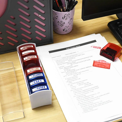 Top Tier Self Inking Office Stamp Set With Eight Gotta Have Rubber Phrases Like Paid And Approved For Smooth Sailing Daily Tasks And Dead Simple Document Management on desk with paperwork.