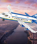 6 In 1 Airport Passenger Plane Building Set With 510 Pieces For STEM Play flying over a cityscape at sunset.