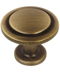 Close-up of brushed antique brass cabinet knob, 1-1/4 inch diameter, part of 25 Pack Brushed Antique Brass Round Cabinet Knobs.