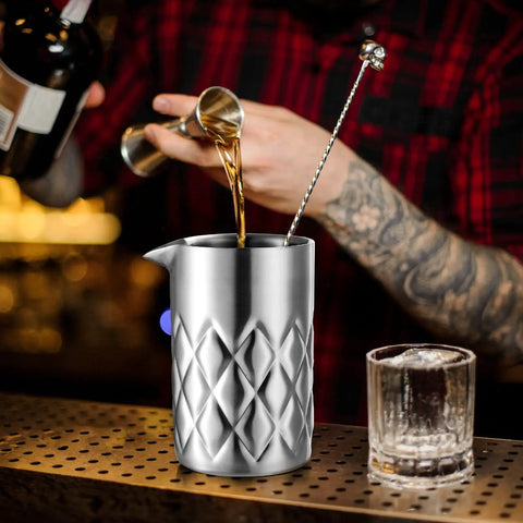 Kickback Ready 18 Oz Stainless Steel Cocktail Mixing Glass with weighted base, pouring liquor for martini mixing.