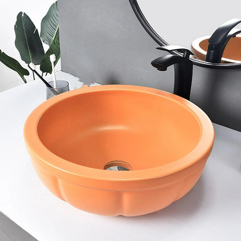 Round Sink Bowls For Bathroom Vessel Sink, 15.7 Inch Ceramic Vessel Sink in orange on counter with faucet and drainer.