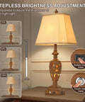 29.5 Inch Tall Touch Control Traditional Table Lamp Set Of 2 With Dual USB Ports 3 Way Dimmable Hollow Out Leafwork Bronze Wood Finish Retro Farmhouse Rustic Look Vintage Bedside Nightstand Desk Lamps For Living Room And Bedroom showing stepless brightness adjustment on a wooden table.