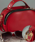 Close-up of red purse with 12 Pieces D Ring Stud Screws With Ball Head Buttons For Purses And Leather DIY Projects in gold.